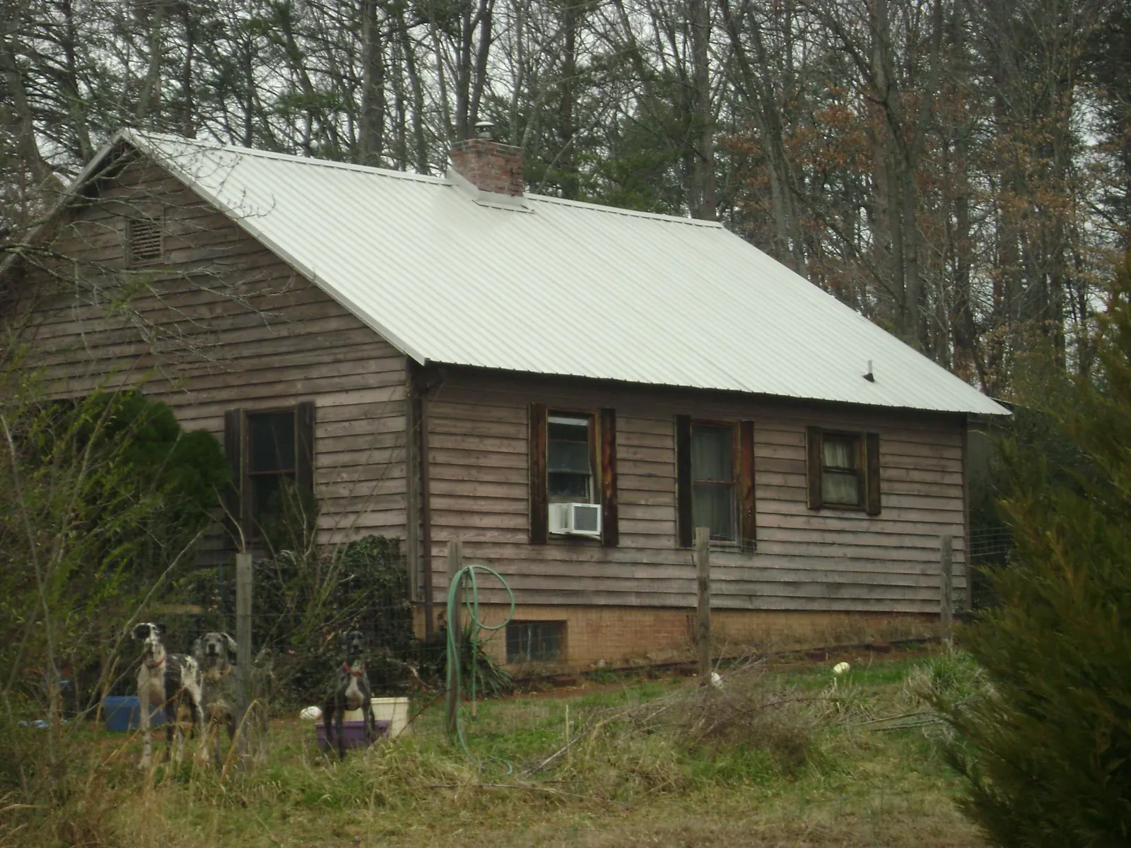 White metal roof on an old wood sided farmhouse, from a Metal Roof Installation job in Brewton